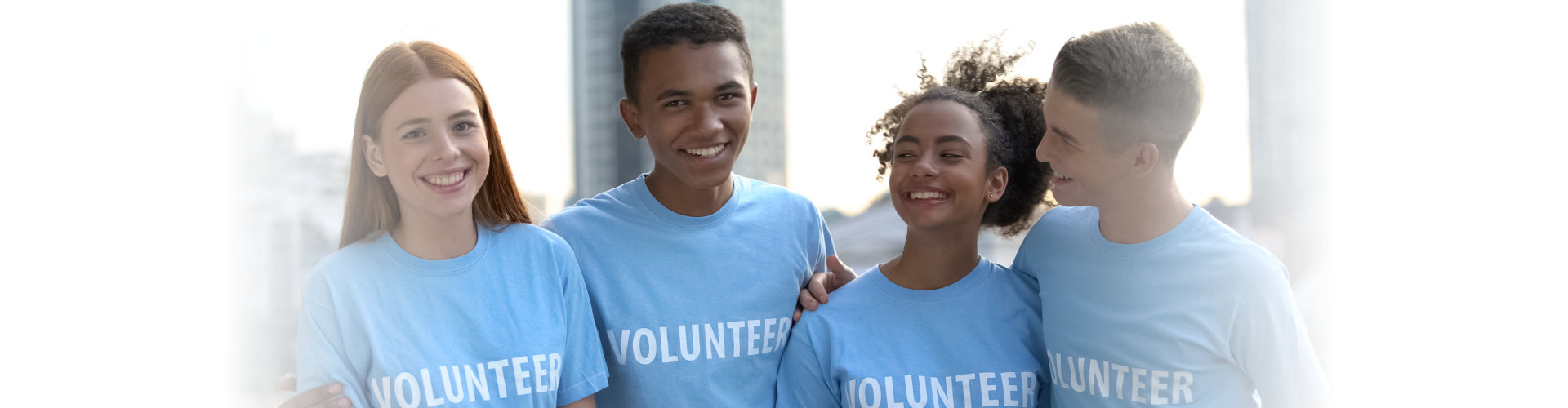 smiling teen group in volunteer t-shirts